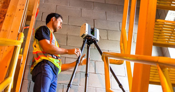 Construction worker documenting construction design using Leica RTC360 3D laser scanner