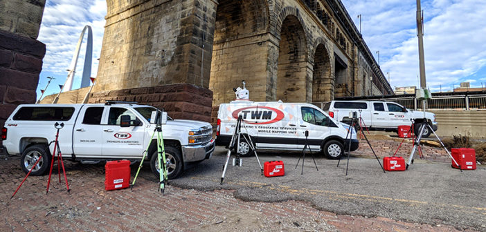 TWM Geospatial Services fleet of vehicles and 3D laser scanning hardware lined up under a bridge