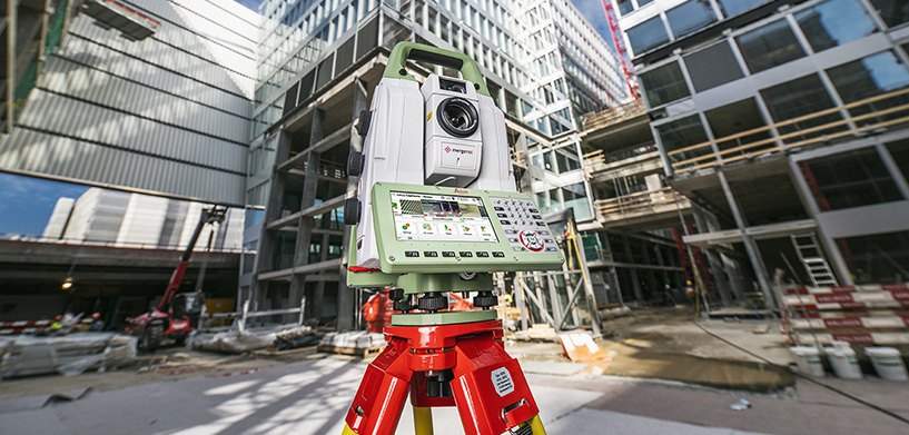 Leica MS60 MultiStation at a construction site with concrete buildings.